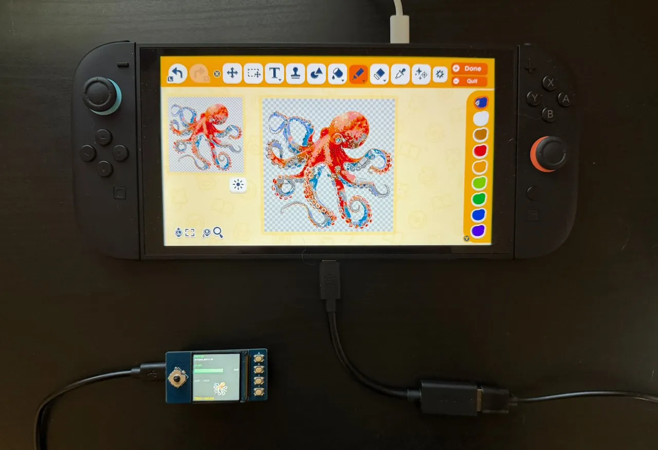Printing the Dream setup: a Nintendo Switch 2ß displaying a red-and-blue octopus drawing, connected by USB to a small controller board.